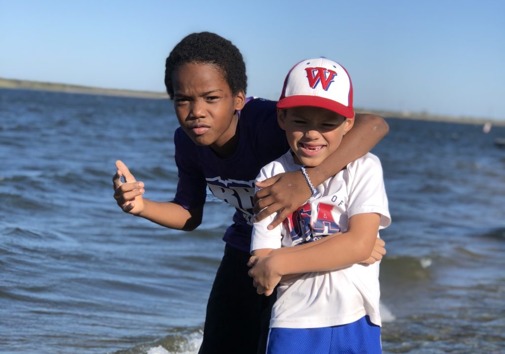 Javion and Isaiah pose for a beach-front picture.