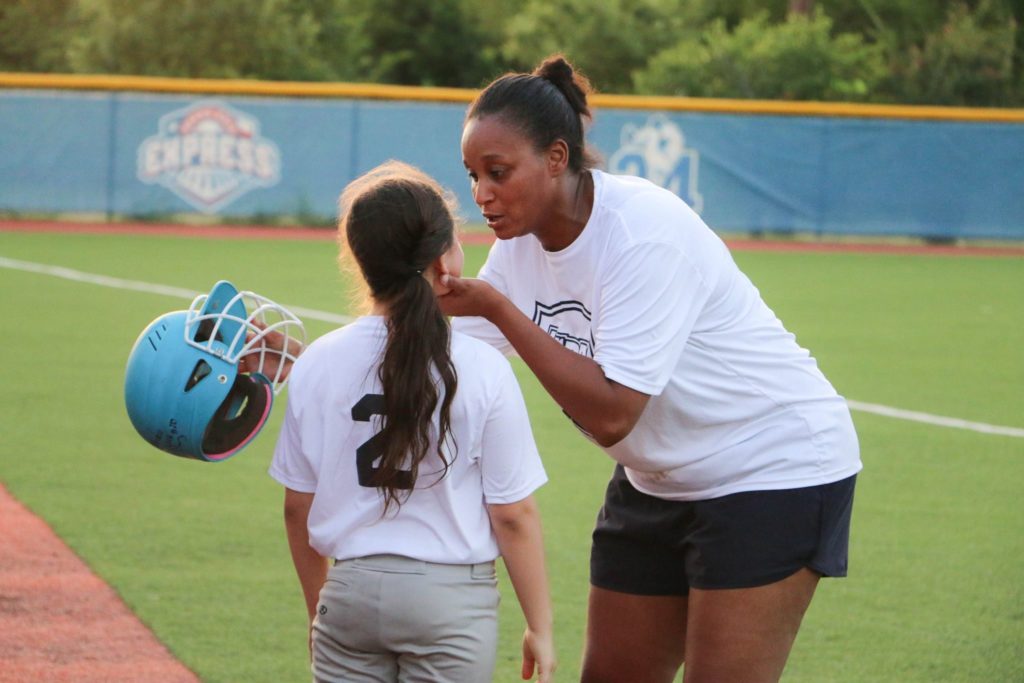 Millicent volunteers as a softball coach.